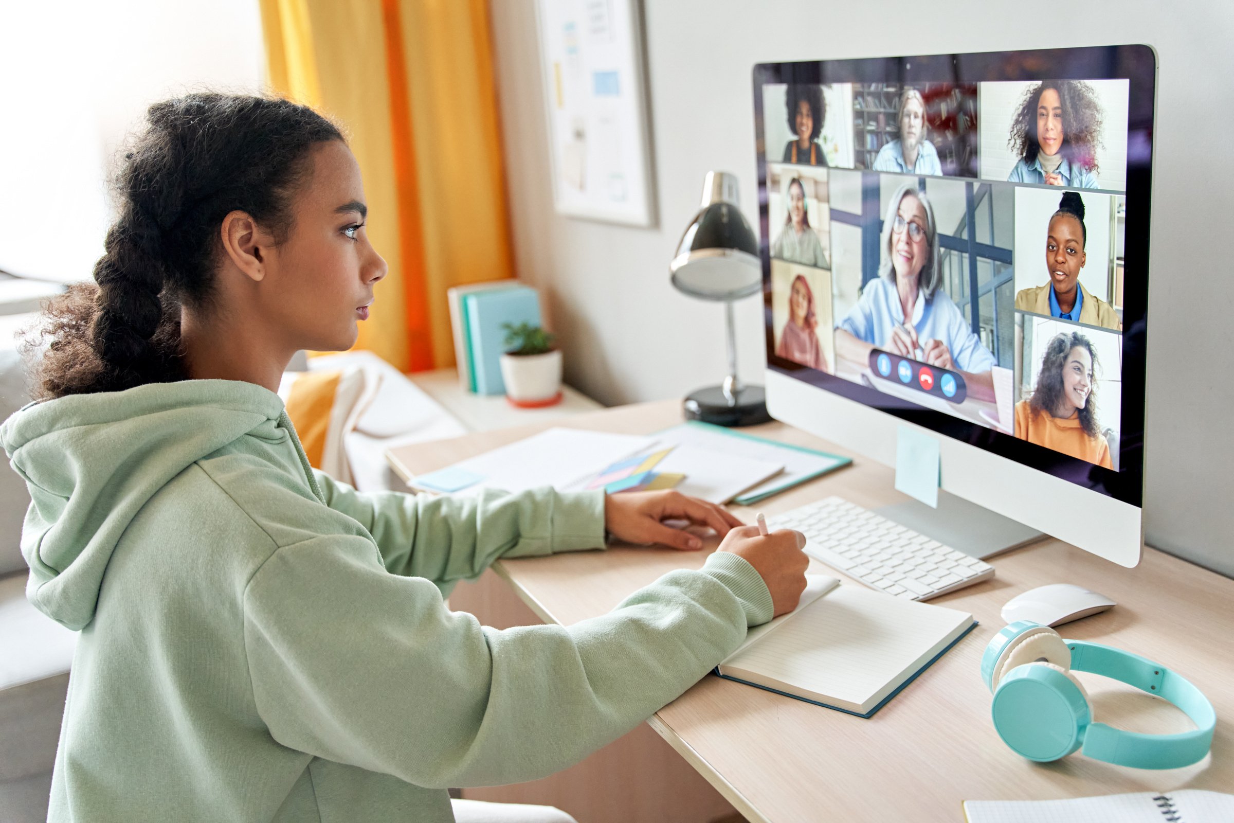 Mixed Race Teen School Girl Remote Learning during Online Group Class.